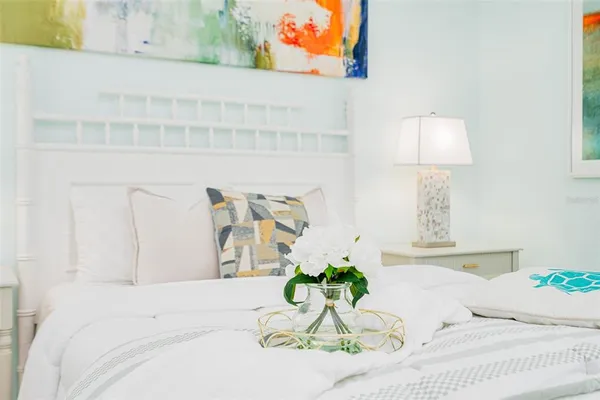 a large bed sitting in a bedroom next to a window