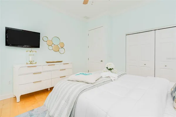 a bedroom with a bed and a chandelier