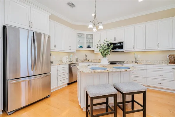 a spacious bedroom with a bed and wooden floor