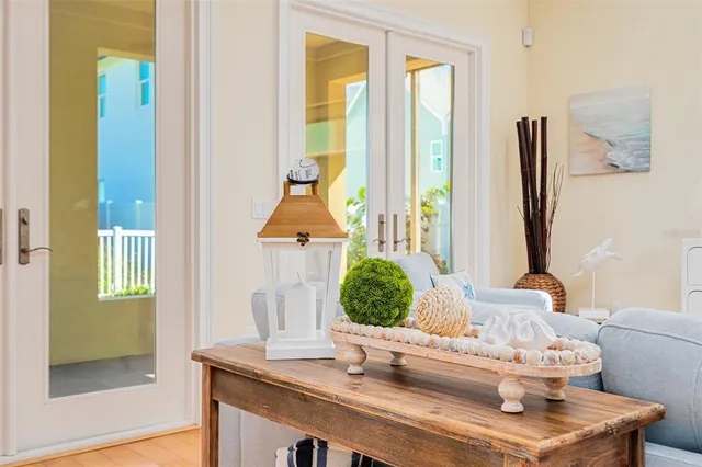 a kitchen with stainless steel appliances granite countertop a sink a stove a refrigerator cabinets and a dining table with wooden floor