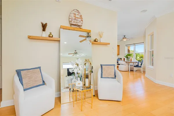 a kitchen with stainless steel appliances kitchen island granite countertop a refrigerator a sink a stove and white cabinets with wooden floor