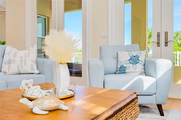 a kitchen with stainless steel appliances kitchen island granite countertop a refrigerator a sink a stove and white cabinets with wooden floor