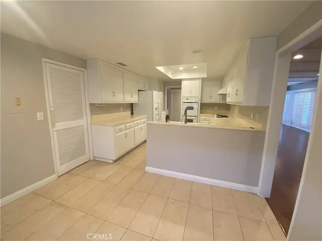a kitchen with cabinets and white appliances