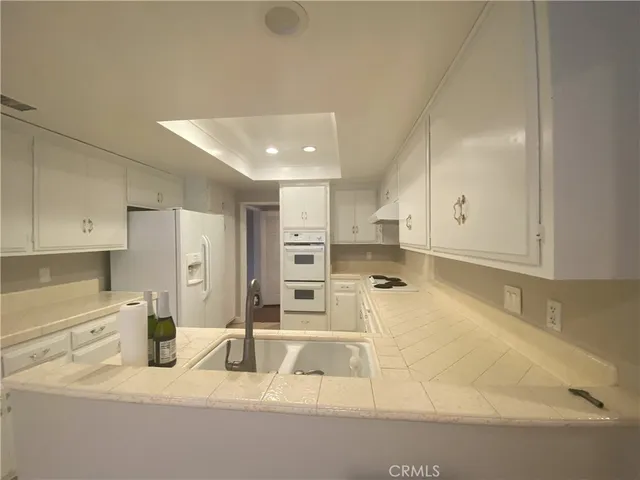 a kitchen with a refrigerator and a sink