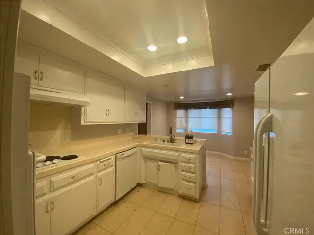 a kitchen with a sink appliances and cabinets