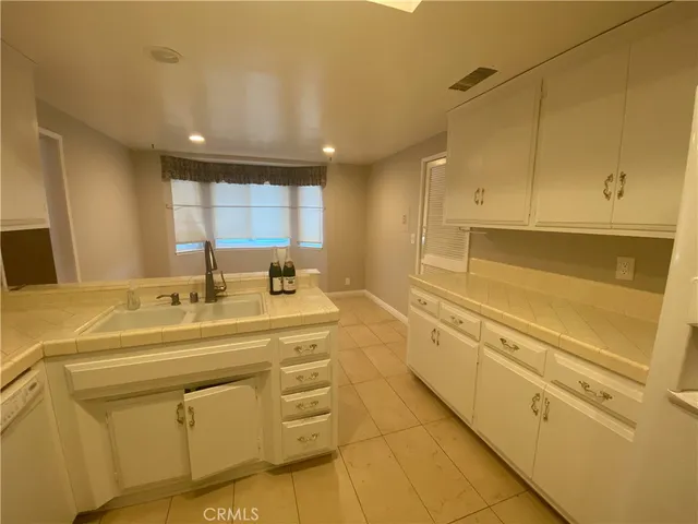 a spacious bathroom with a sink and a mirror