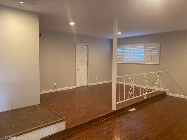 a view of a room with wooden floor
