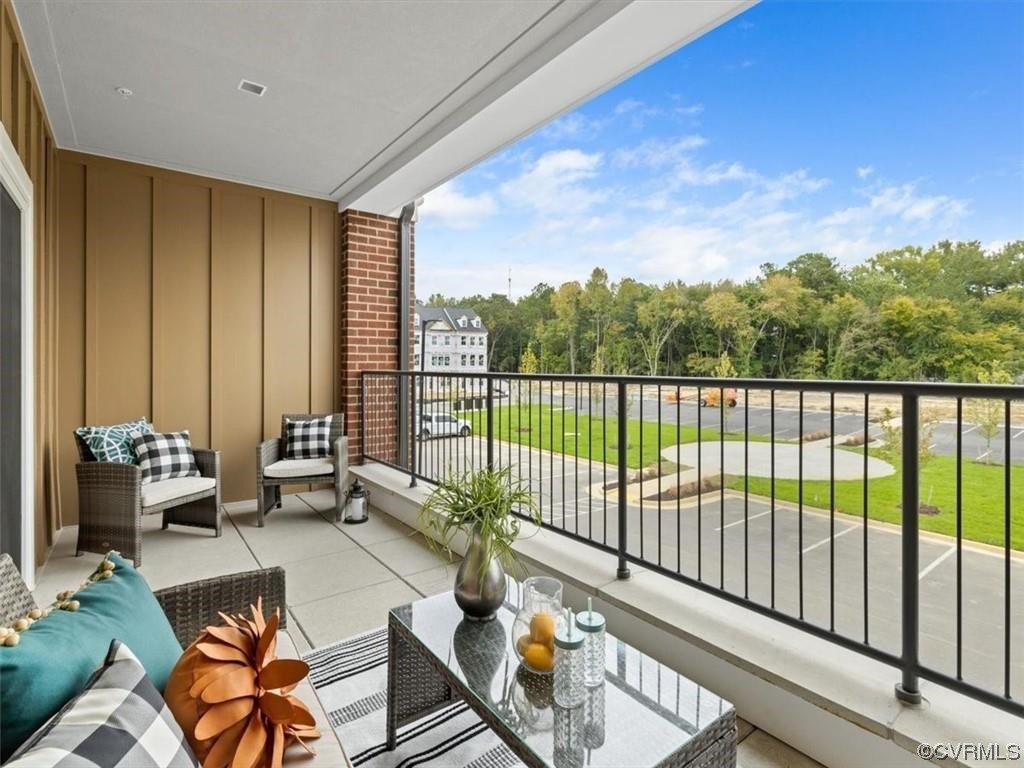 1504 Ewing Park Loop, Unit 202 Midlothian, VA 23113 - Photo 20 of 26 a balcony with furniture and a potted plant