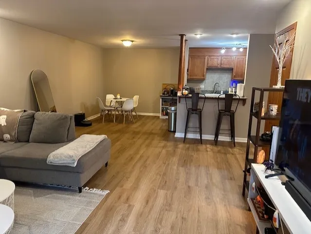 a living room with furniture and wooden floor