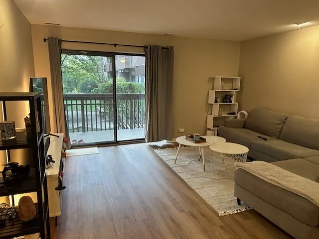 a living room with furniture and a floor to ceiling window