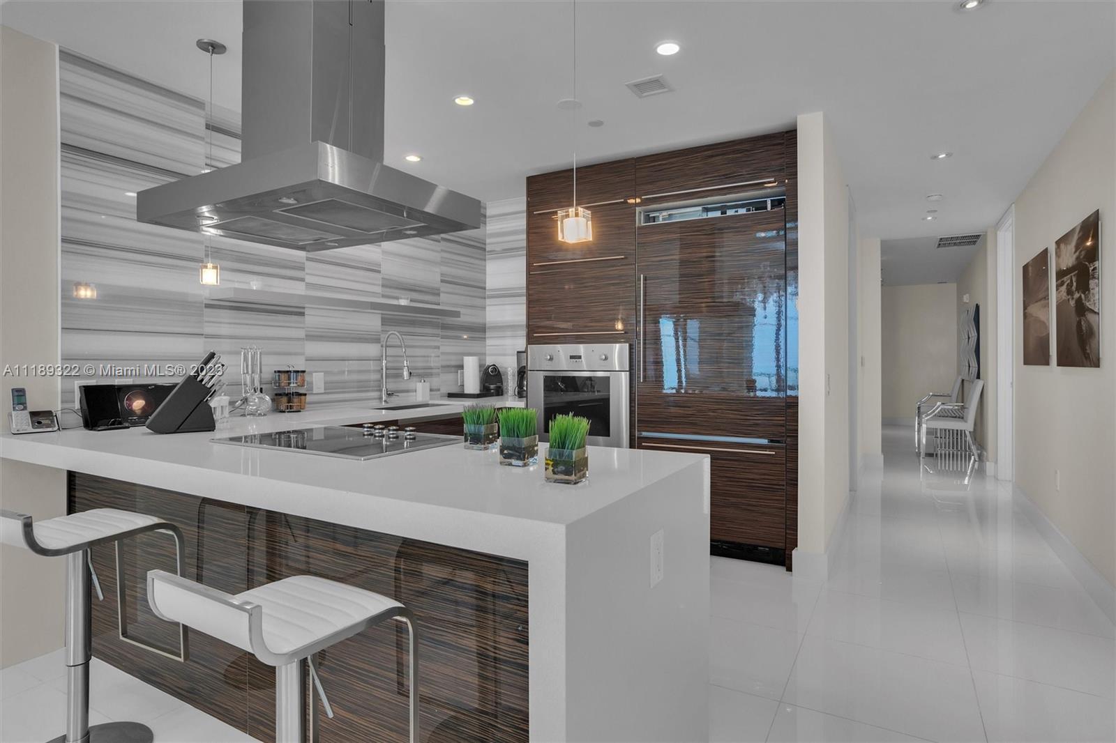a kitchen with stainless steel appliances kitchen island granite countertop a sink and cabinets