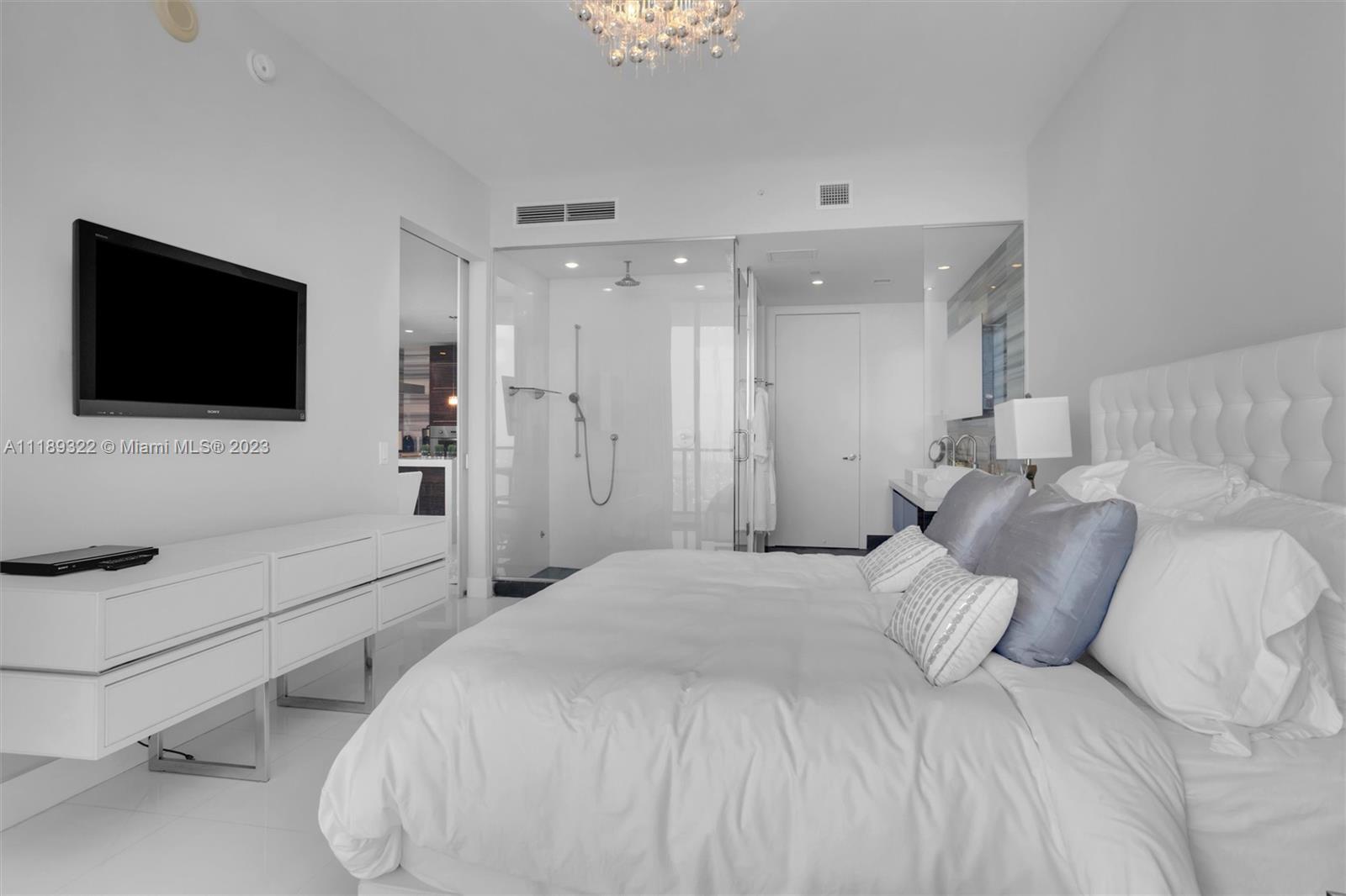 1100 Biscayne Boulevard, Unit 4204 Miami, FL 33132 - Photo 12 of 30 a bedroom with a bed and a flat screen tv