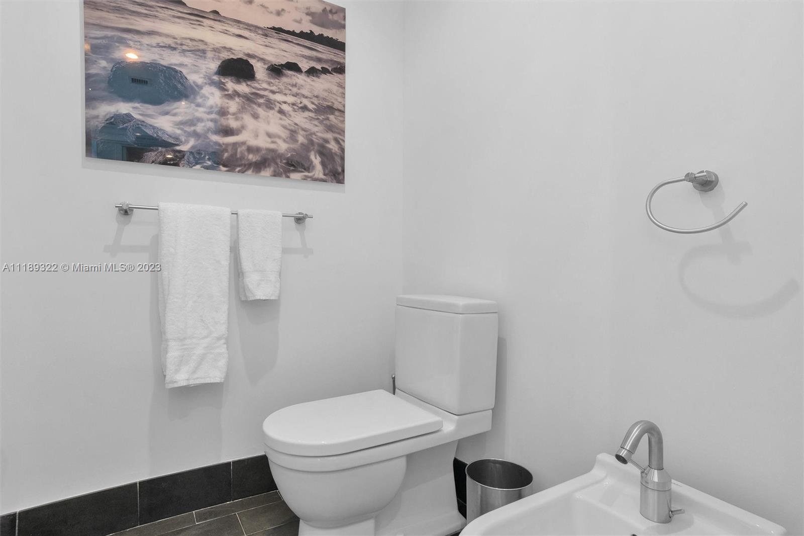 1100 Biscayne Boulevard, Unit 4204 Miami, FL 33132 - Photo 17 of 30 a white toilet sitting next to a bathroom sink