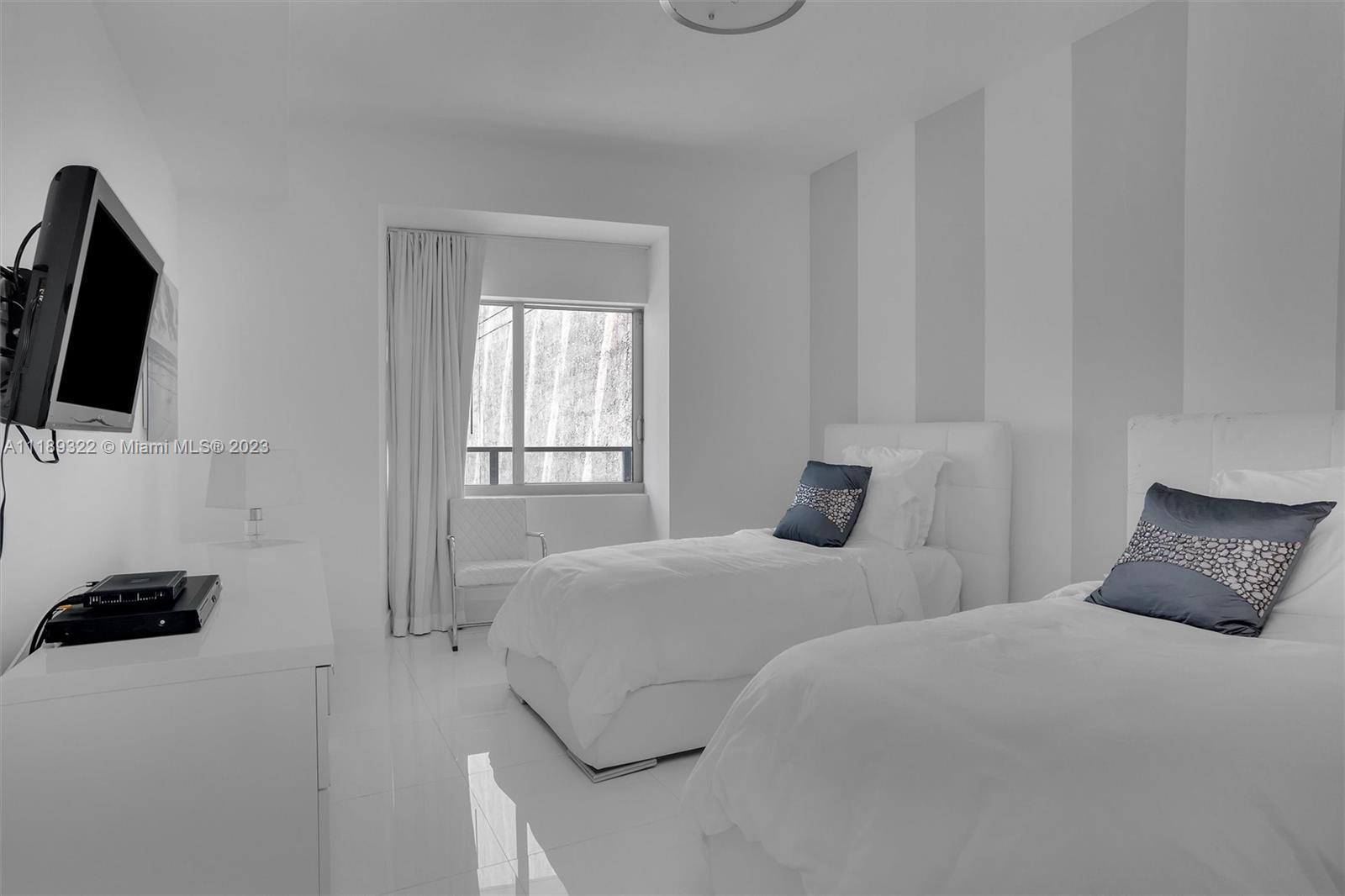 1100 Biscayne Boulevard, Unit 4204 Miami, FL 33132 - Photo 18 of 30 a bedroom with a bed and a television