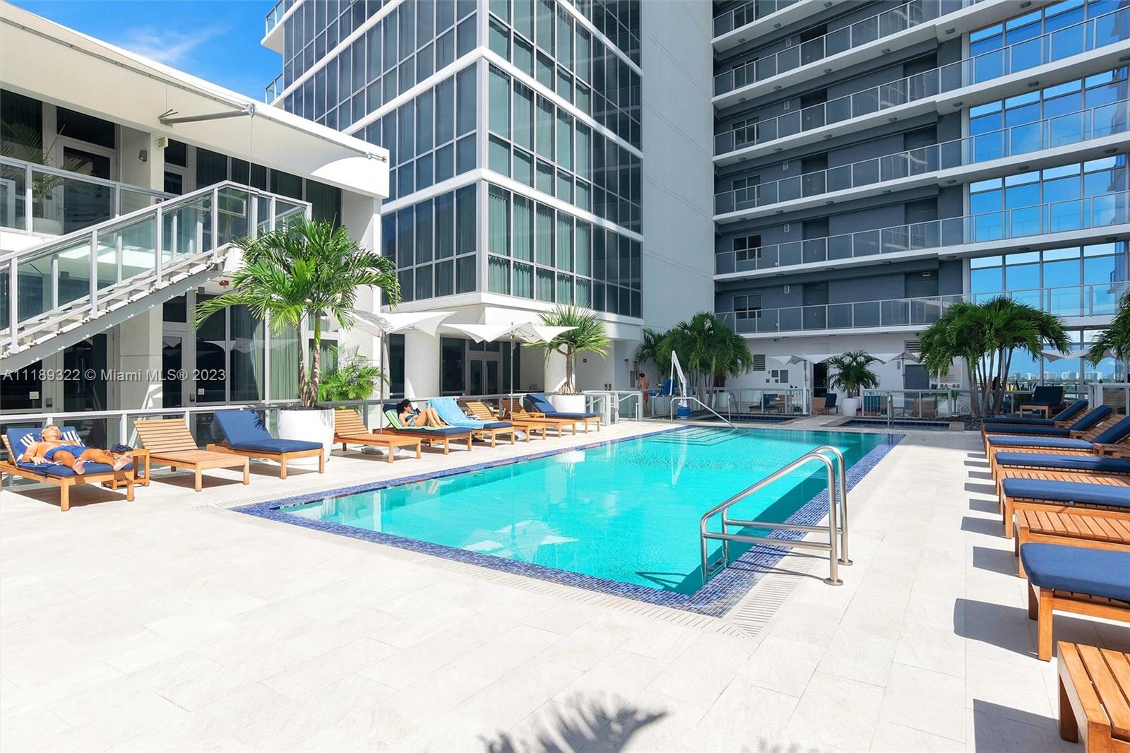1100 Biscayne Boulevard, Unit 4204 Miami, FL 33132 - Photo 29 of 30 a view of a swimming pool with a lounge chairs