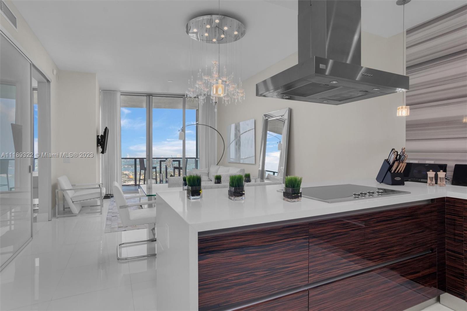 1100 Biscayne Boulevard, Unit 4204 Miami, FL 33132 - Photo 4 of 30 a kitchen with stainless steel appliances kitchen island granite countertop a sink and cabinets