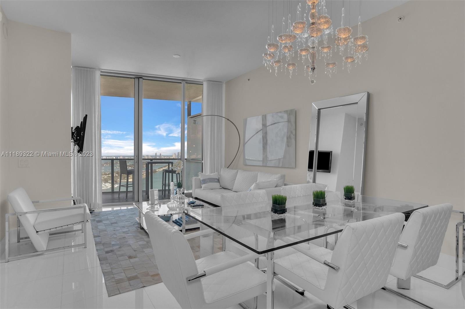 1100 Biscayne Boulevard, Unit 4204 Miami, FL 33132 - Photo 6 of 30 a living room with furniture and a chandelier