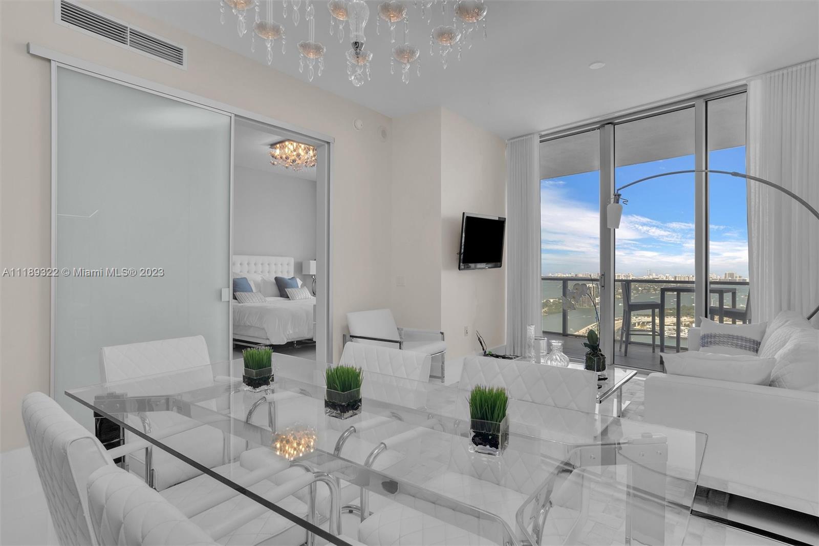 1100 Biscayne Boulevard, Unit 4204 Miami, FL 33132 - Photo 7 of 30 a living room with furniture and a potted plant