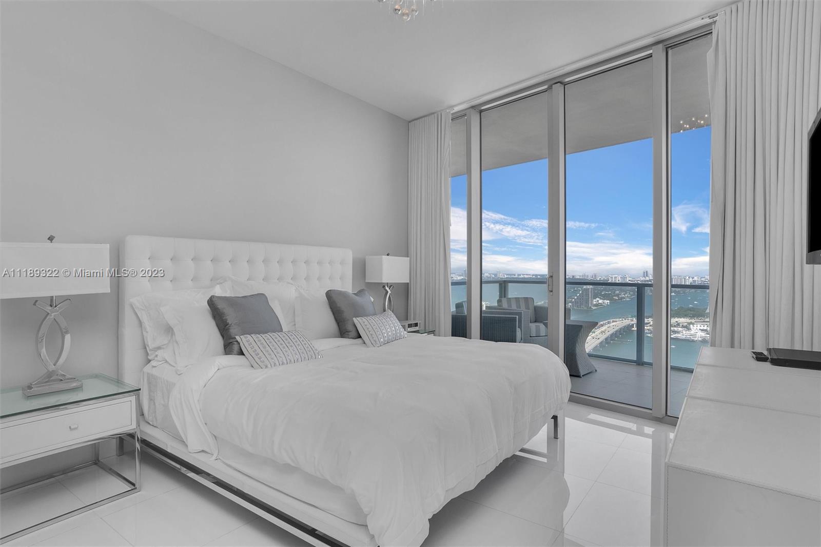 1100 Biscayne Boulevard, Unit 4204 Miami, FL 33132 - Photo 10 of 30 a bedroom with a large bed and a large window