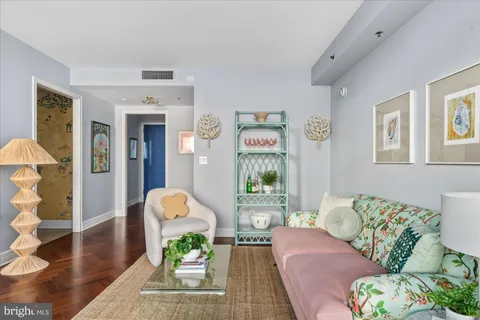 a living room with furniture and a potted plant