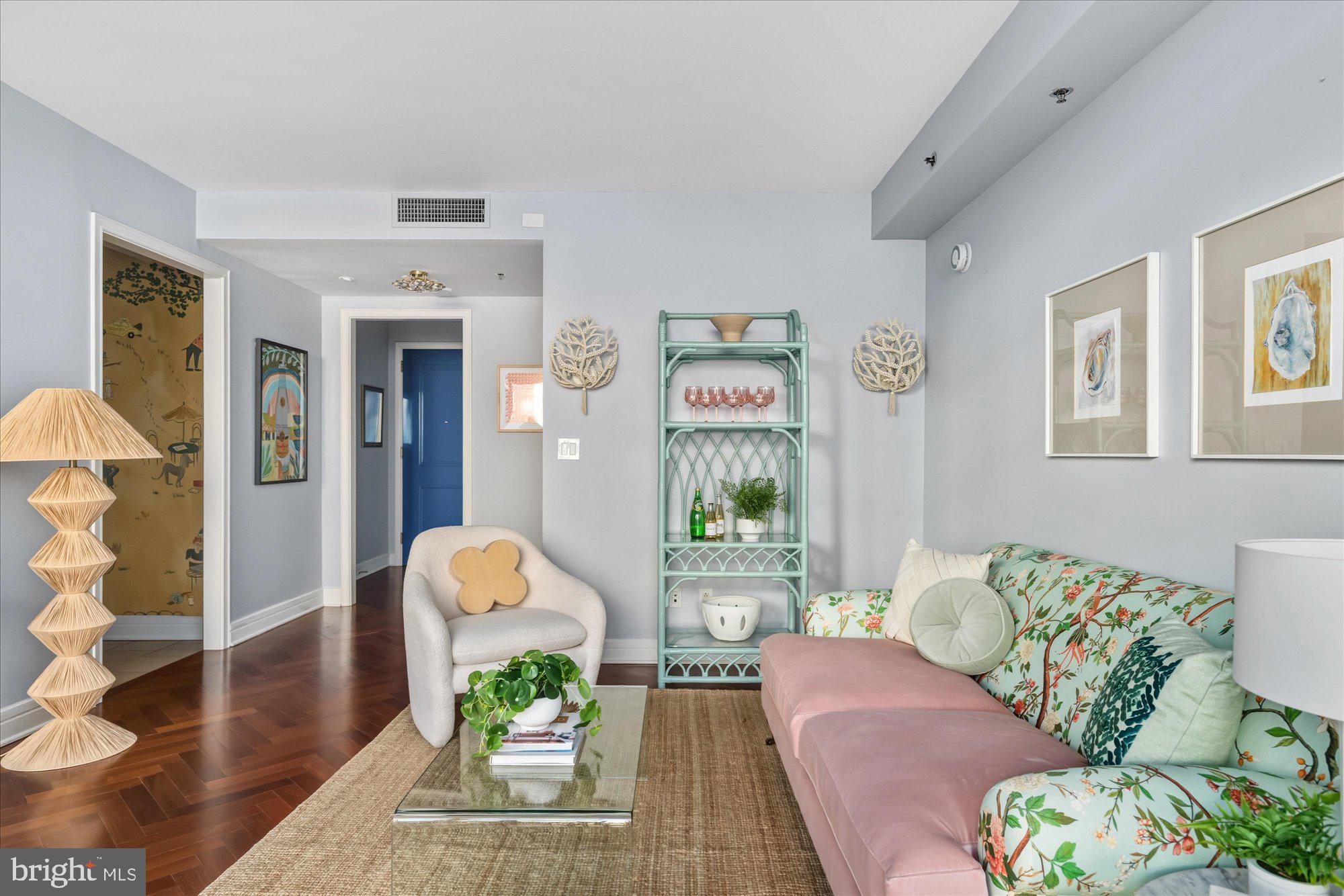 1155 23rd Street Northwest, Unit 8H Washington, DC 20037 - Photo 3 of 22 a living room with furniture and a potted plant