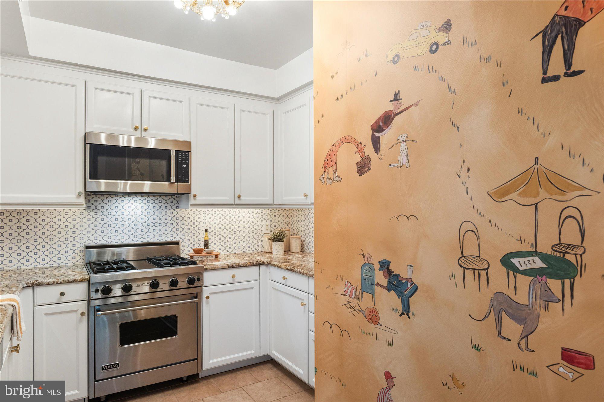 1155 23rd Street Northwest, Unit 8H Washington, DC 20037 - Photo 7 of 22 a kitchen with stainless steel appliances a stove a microwave and cabinets