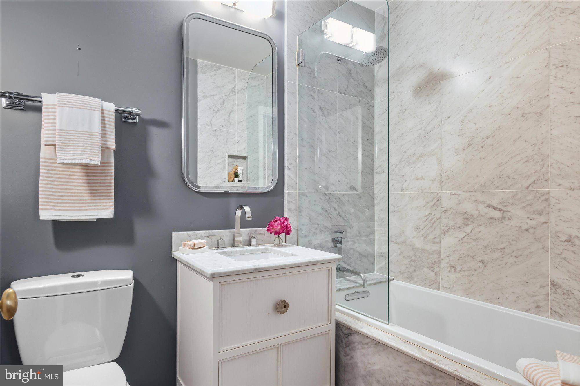 1155 23rd Street Northwest, Unit 8H Washington, DC 20037 - Photo 10 of 22 a bathroom with a sink toilet vanity and bathtub
