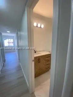 a view of hallway with stairs and wooden floor