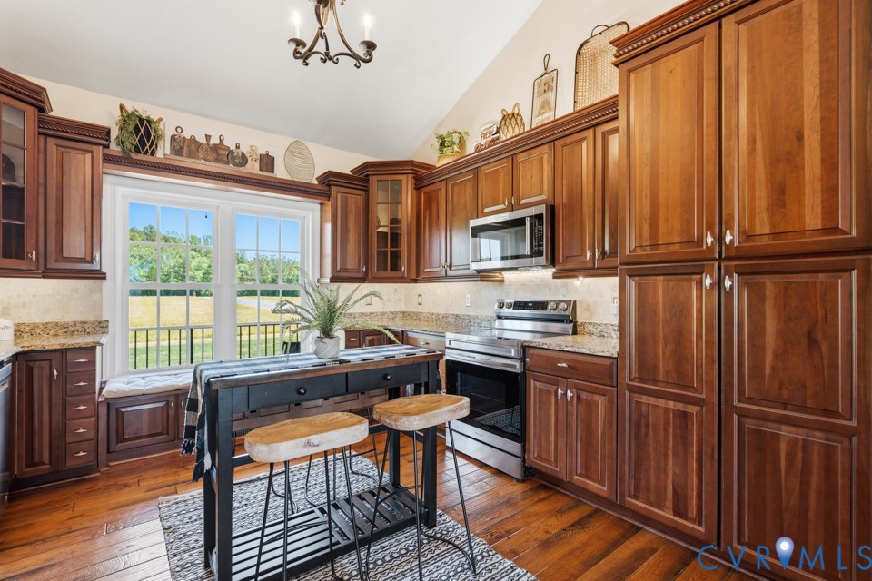 7191 Figuly Road Mechanicsville, VA 23111 - Photo 12 of 46 a kitchen with granite countertop wooden cabinets and stainless steel appliances