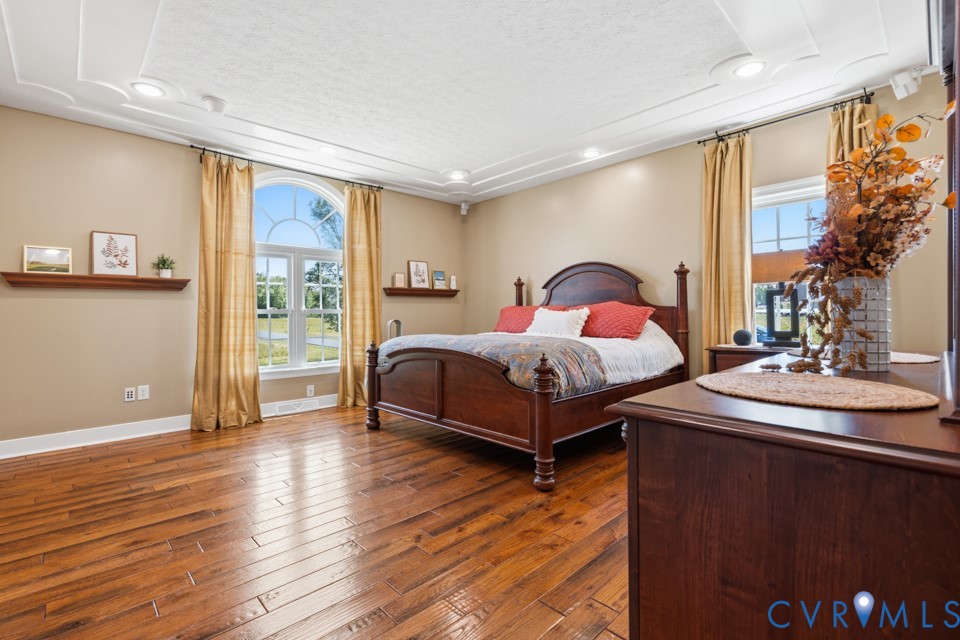 7191 Figuly Road Mechanicsville, VA 23111 - Photo 16 of 46 a spacious bedroom with a bed and wooden floor