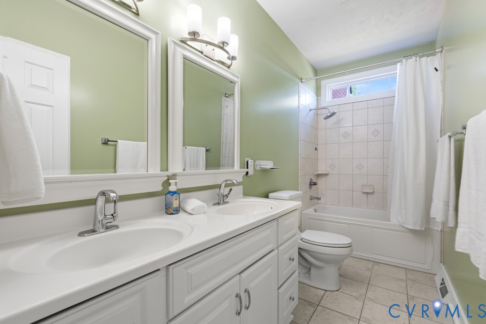7191 Figuly Road Mechanicsville, VA 23111 - Photo 25 of 46 a bathroom with a double vanity sink toilet mirror and shower