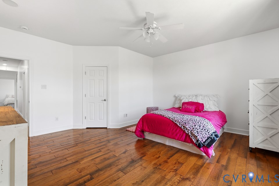 7191 Figuly Road Mechanicsville, VA 23111 - Photo 27 of 46 a view of a bedroom with a bed and wooden floor