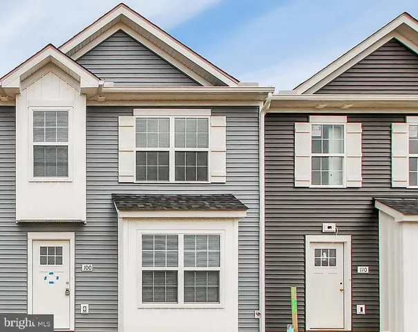 a front view of a house with large windows