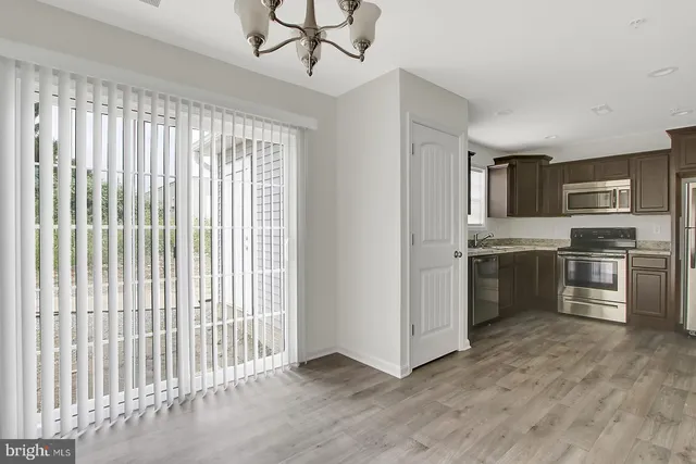 a kitchen with a refrigerator and a sink