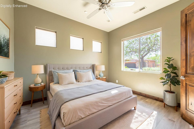 322 340 E Street Ivins, UT 84738 - Photo 43 of 61 Bedroom featuring light wood-finish flooring, a ceiling fan, a large window, and three high square windows