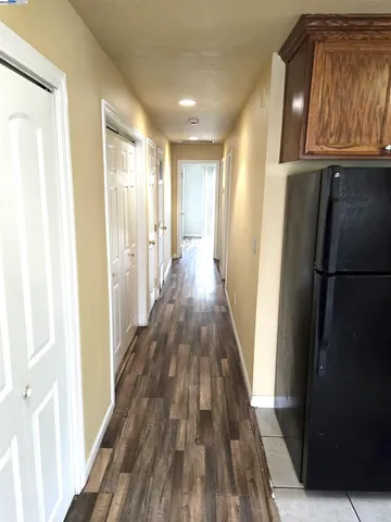 a view of a hallway with wooden floor