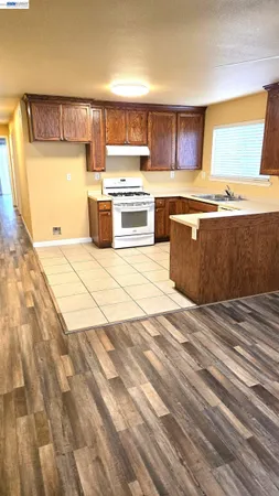 a kitchen with a stove a sink and a microwave