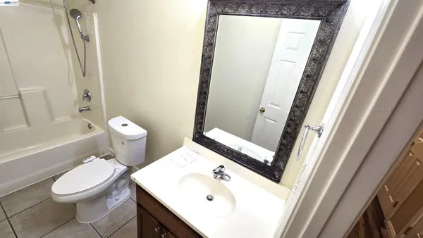 a white toilet sitting next to a bathroom sink