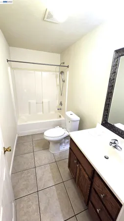 a bathroom with a sink a toilet a mirror and shower