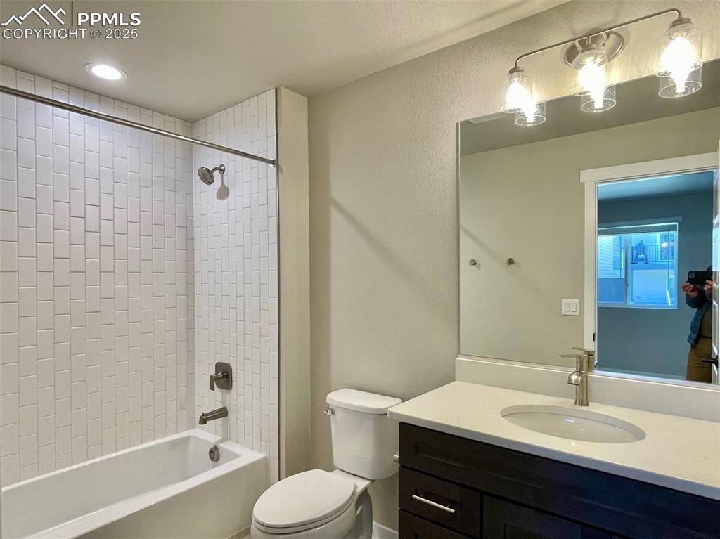 3527 Summer Dream Avenue Colorado Springs, CO 80922 - Photo 13 of 26 a bathroom with a sink a toilet and shower
