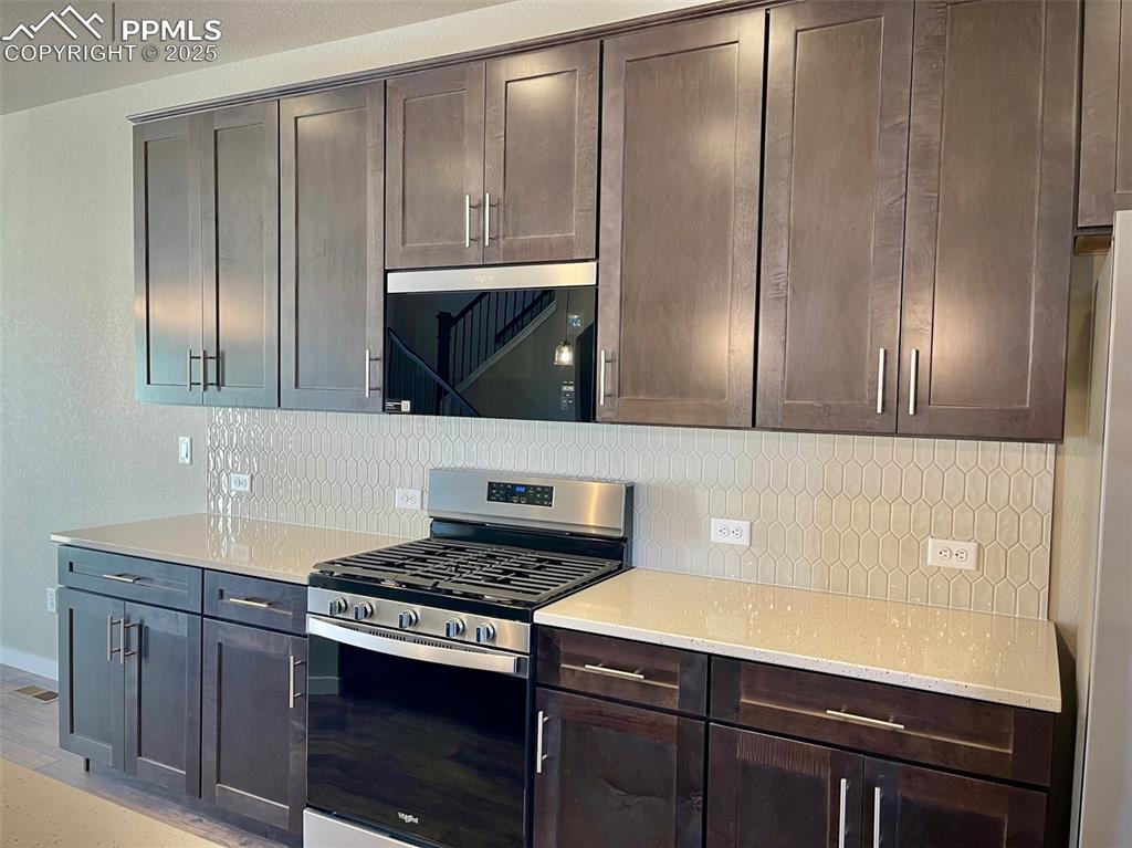3527 Summer Dream Avenue Colorado Springs, CO 80922 - Photo 4 of 26 a kitchen with granite countertop stainless steel appliances and cabinets