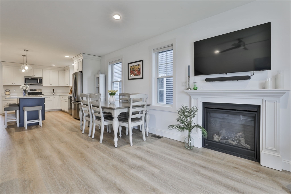 207 Beach Road, Unit C2 Salisbury, MA 01952 - Photo 17 of 35 a living room with furniture a flat screen tv and a fireplace