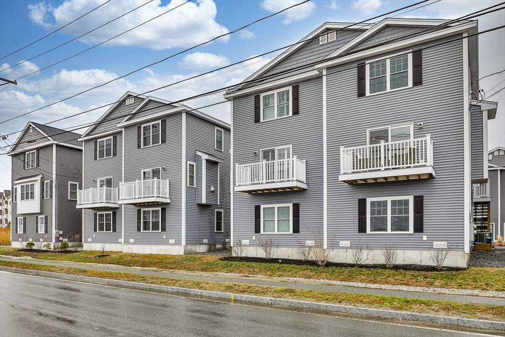 207 Beach Road, Unit C2 Salisbury, MA 01952 - Photo 2 of 35 a view of a building with a swimming pool