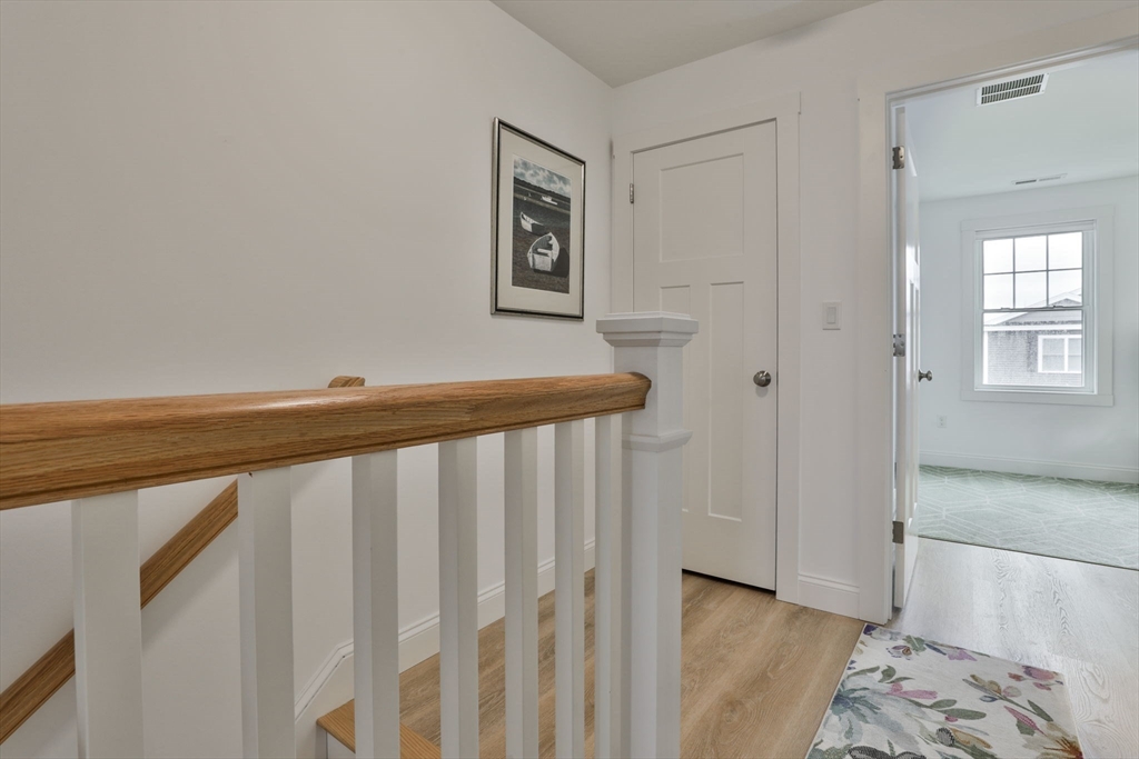 207 Beach Road, Unit C2 Salisbury, MA 01952 - Photo 24 of 35 a view of a hallway with bed and wooden floor