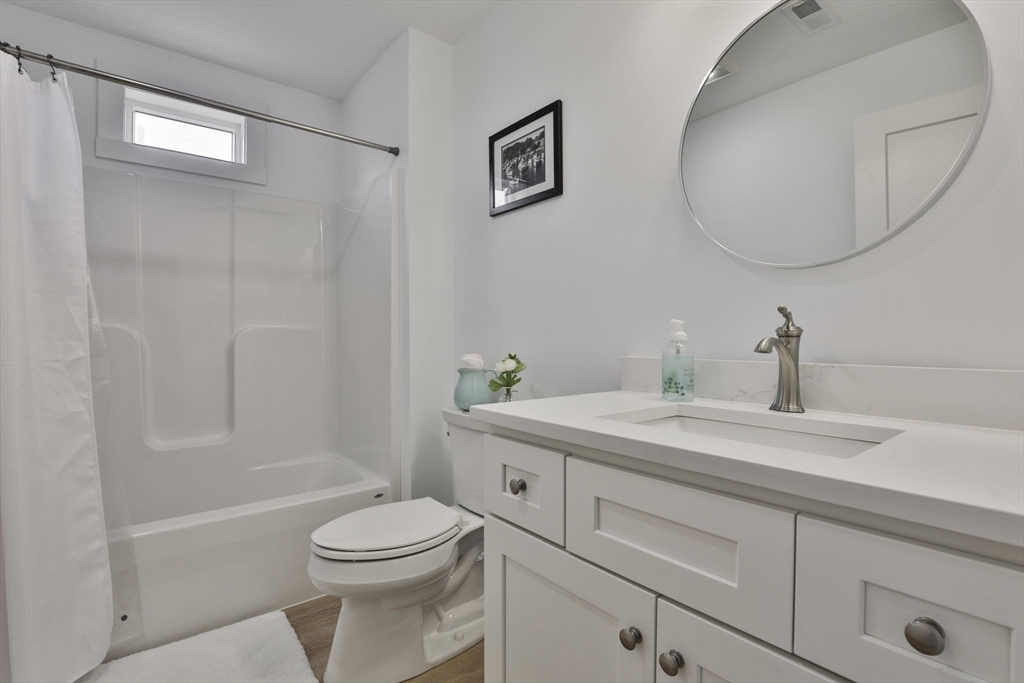 207 Beach Road, Unit C2 Salisbury, MA 01952 - Photo 27 of 35 a bathroom with a sink a toilet and a mirror
