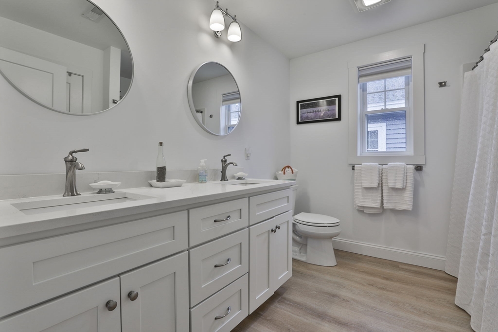 207 Beach Road, Unit C2 Salisbury, MA 01952 - Photo 31 of 35 a bathroom with 2 sink toilet and a mirror