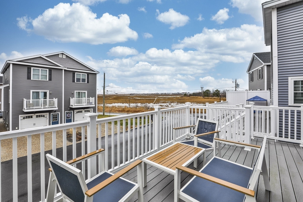 207 Beach Road, Unit C2 Salisbury, MA 01952 - Photo 32 of 35 a view of a balcony with wooden floor and city view