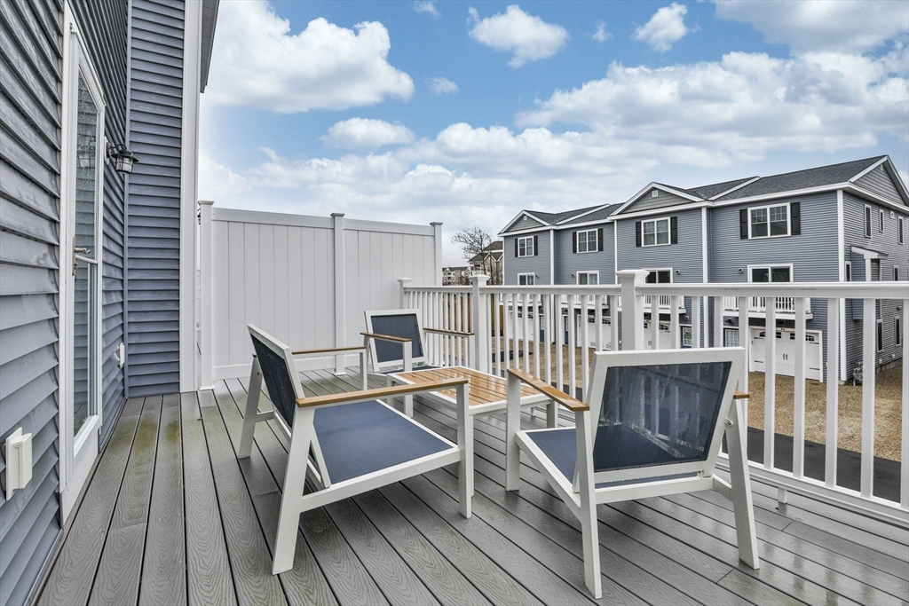 207 Beach Road, Unit C2 Salisbury, MA 01952 - Photo 33 of 35 a view of a roof deck with table and chairs with wooden floor and fence