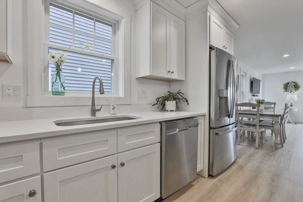 207 Beach Road, Unit C2 Salisbury, MA 01952 - Photo 8 of 35 a kitchen with white cabinets and sink