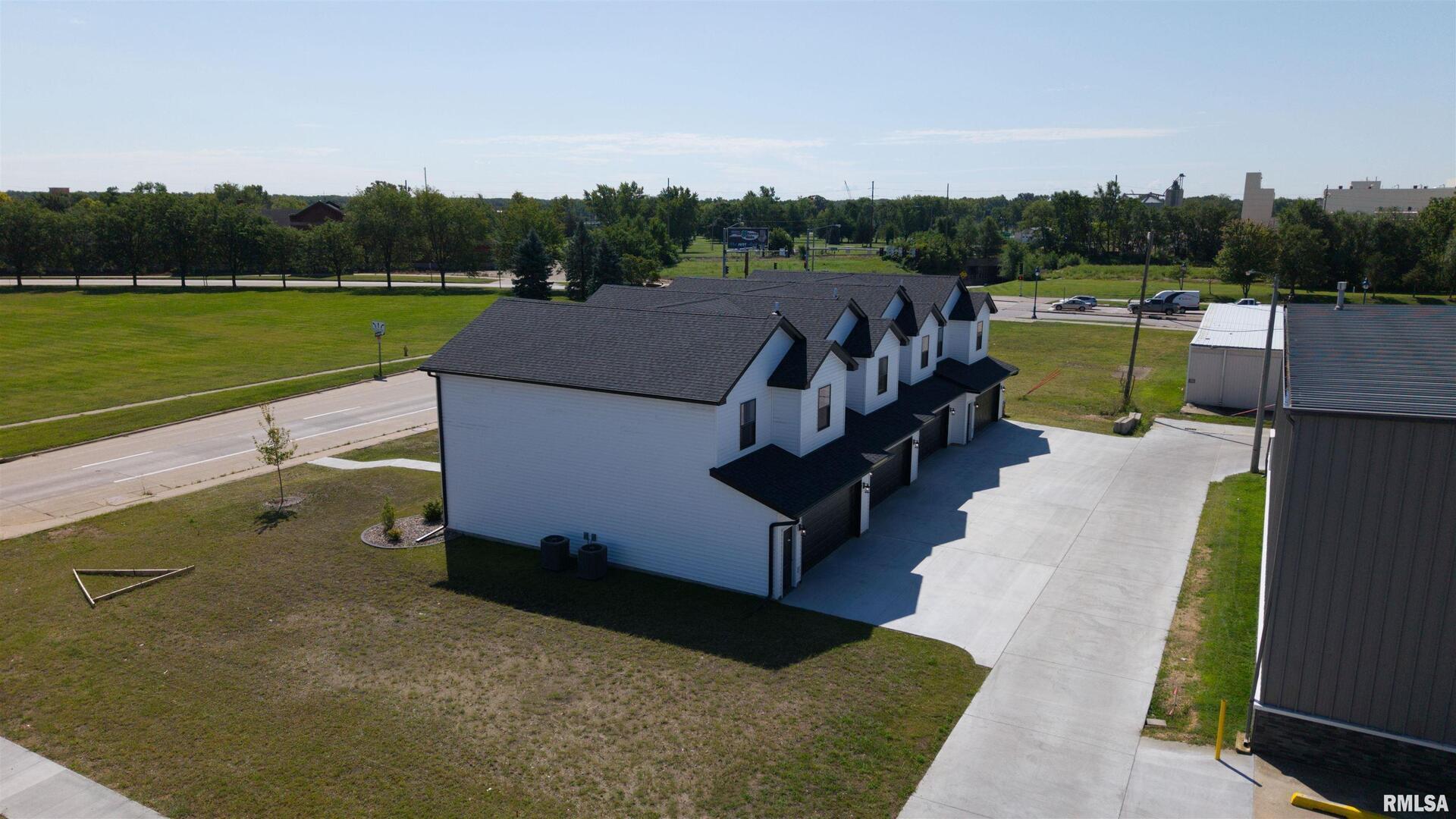 1002 South 4th Street Clinton, IA 52732 - Photo 17 of 19 an aerial view of a house with a garden and lake view